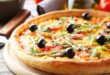 Fresh tasty pizza on grey wooden background