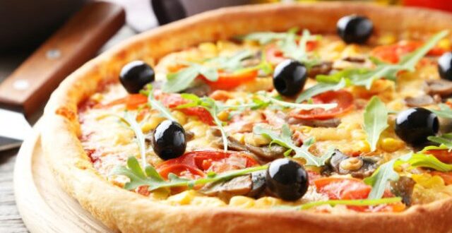 Fresh tasty pizza on grey wooden background