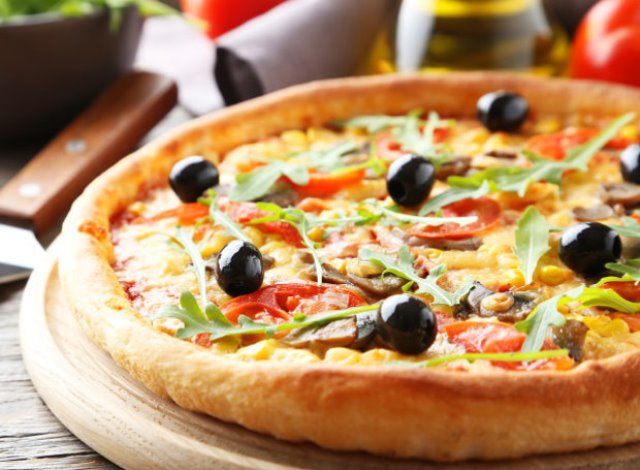 Fresh tasty pizza on grey wooden background